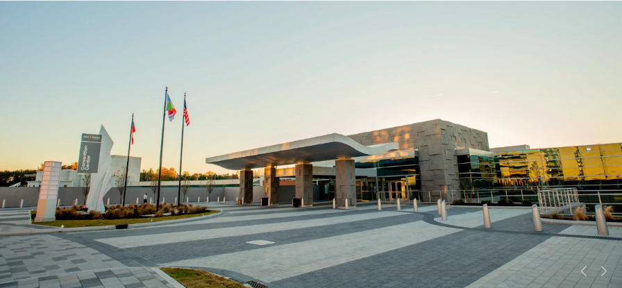 A building with flags in front of itDescription automatically generated